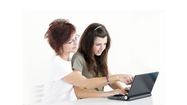 Parent and young person looking at a laptop