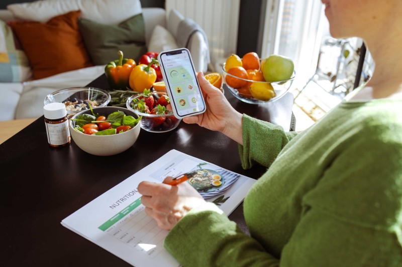 A woman looking at a nutrition app on her phone