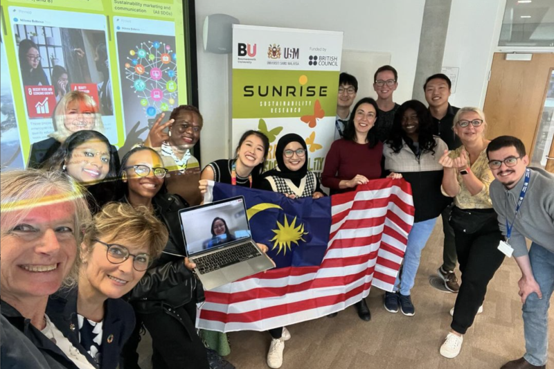 The SUNRISE project team holding a Malaysian flag