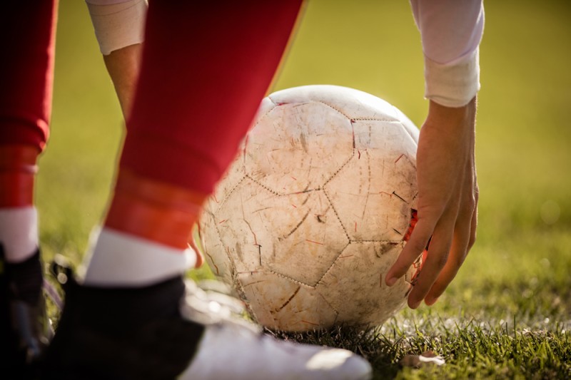 Close up of a ball being placed on the pitch