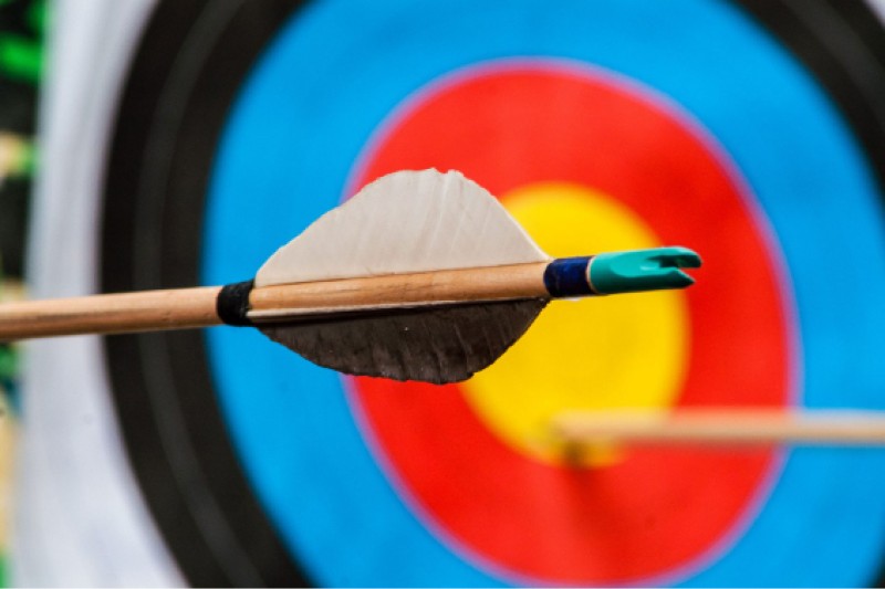 Image of an archery target and arrow