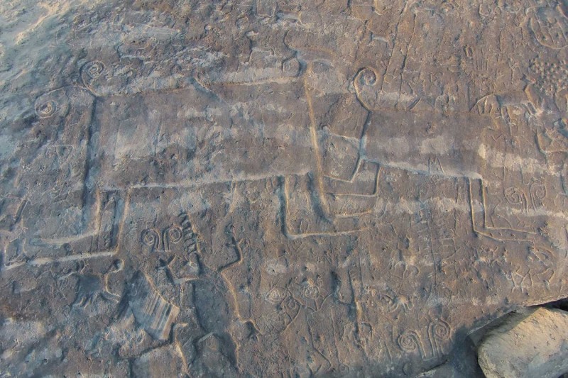 Several carvings and engravings of different shapes on a rock